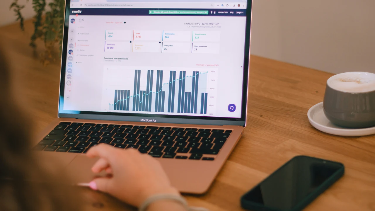 Professional reviewing business charts on a laptop.