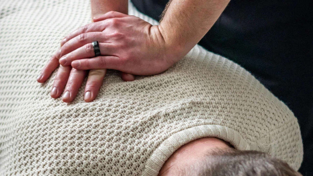 Authentic photograph of chiropractor adjusting patients upper back and neck.