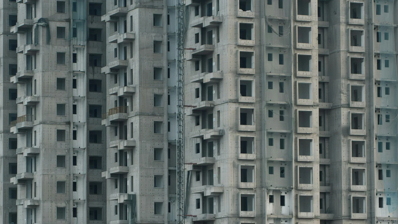 Authentic photograph of unfinished high rise apartment building under construction.