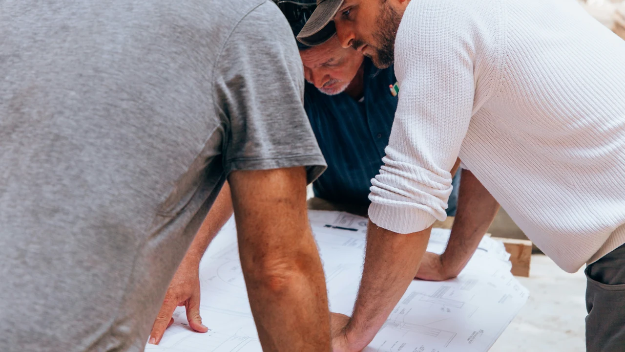 Authentic photograph of a group of men working on a project.