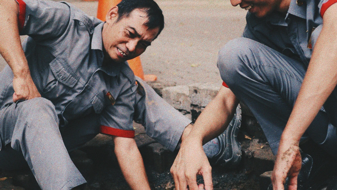 Workers repairing a real pipe on site.