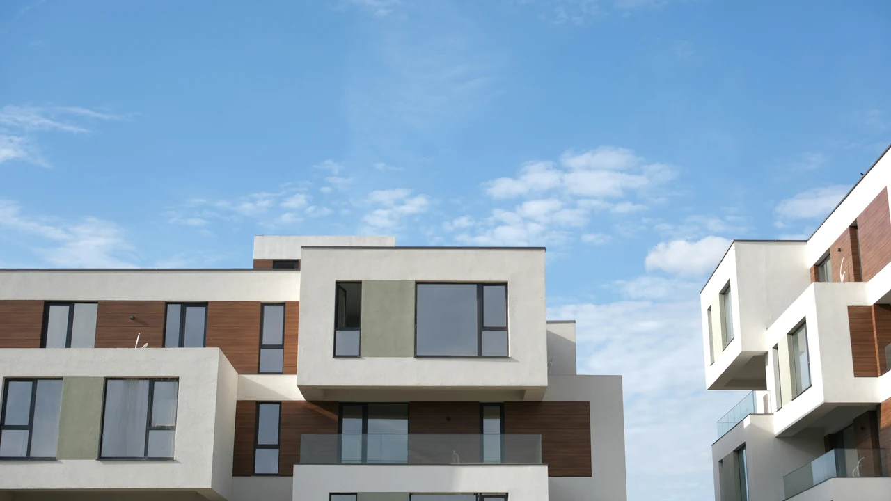Authentic photograph of modern apartment buildings against a blue sky.