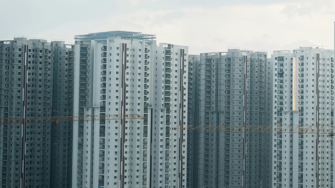 Authentic photograph of rows of identical apartment buildings under a cloudy sky.