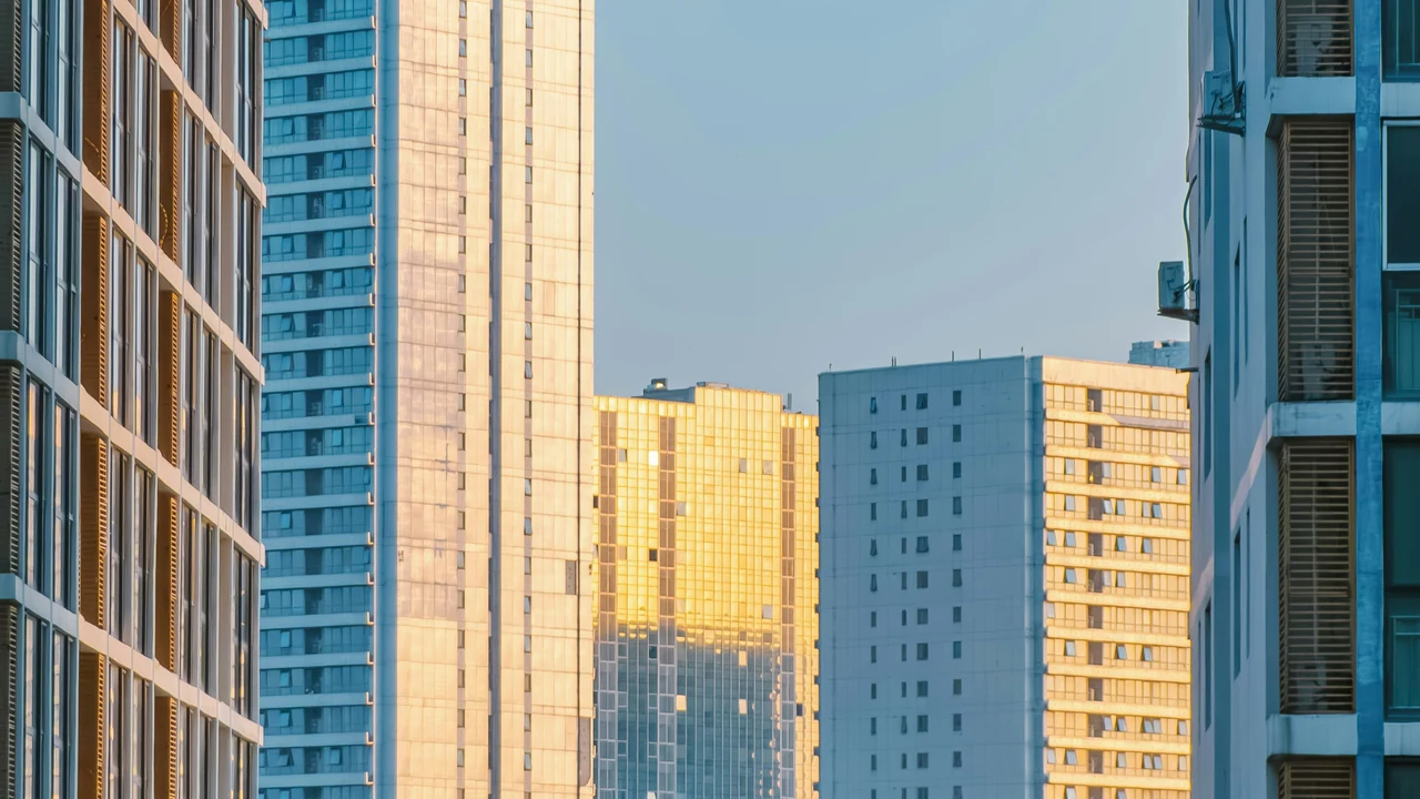 Authentic photograph of modern apartment buildings bathed in golden hour light.