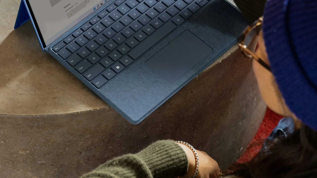 Authentic photograph of a person using a laptop.