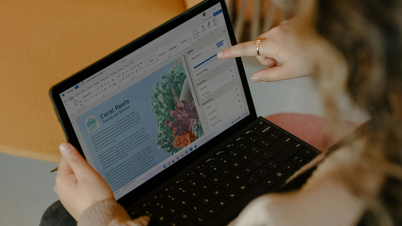 Authentic photograph of a person using a laptop.