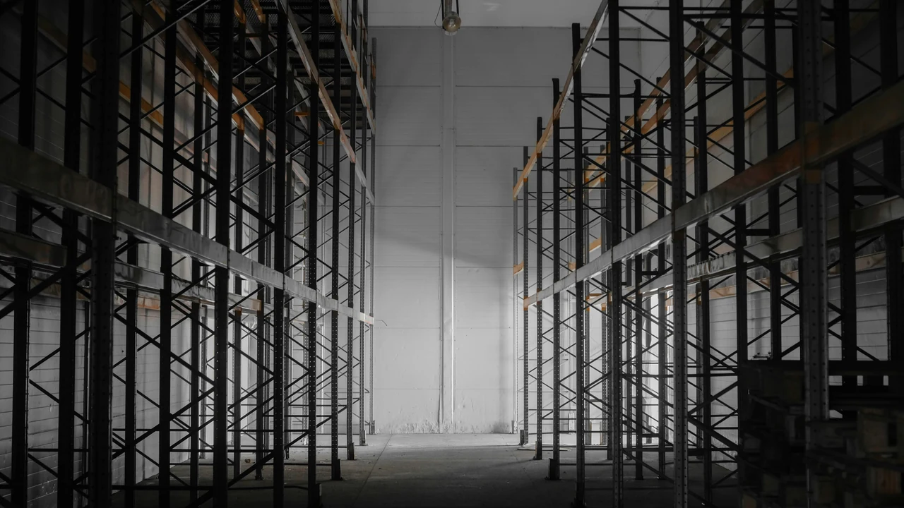 Authentic photograph of a dark room filled with lots of shelves.