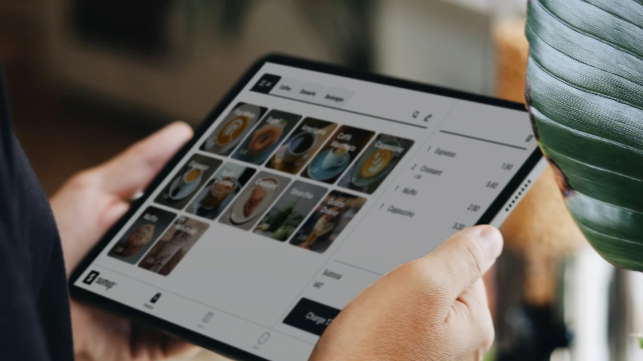 Authentic photograph of a person holding a tablet in their hands.