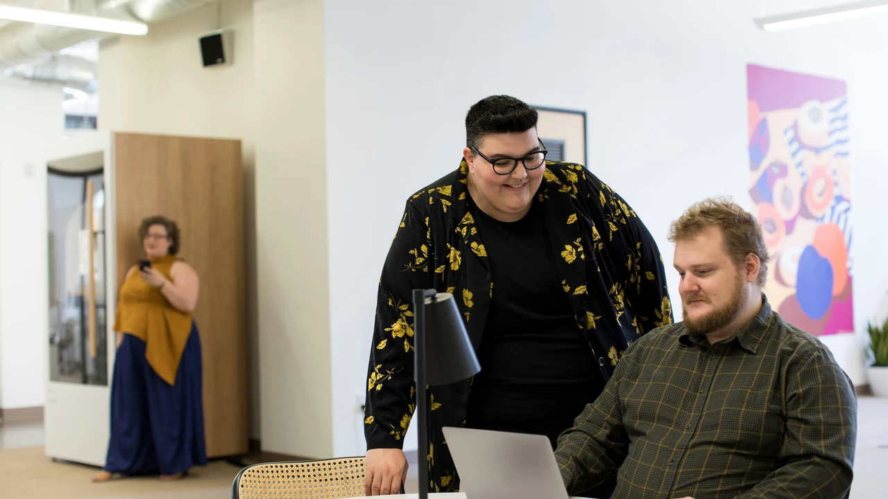 Authentic photograph of man using laptop on desk.