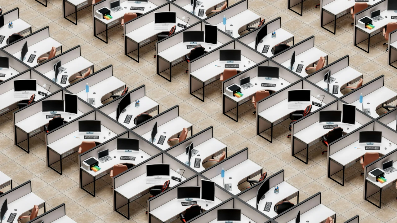 Authentic photograph of a room filled with lots of desks and computers.