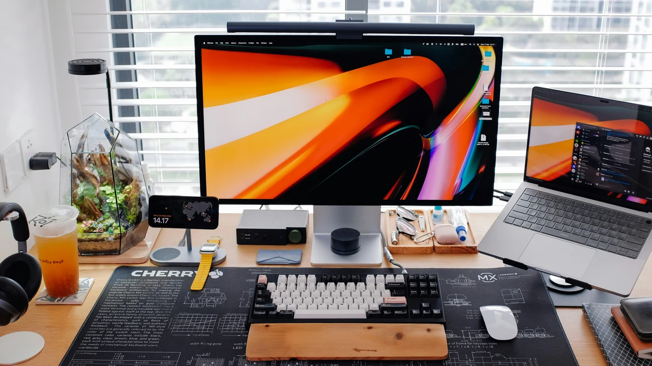 Authentic photograph of a sleek modern desk setup with multiple screens.