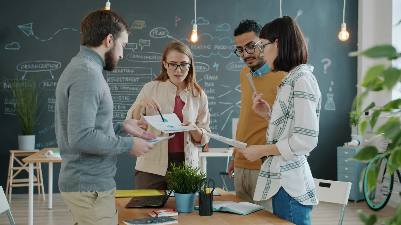 Diverse team collaborating on a project in an office.