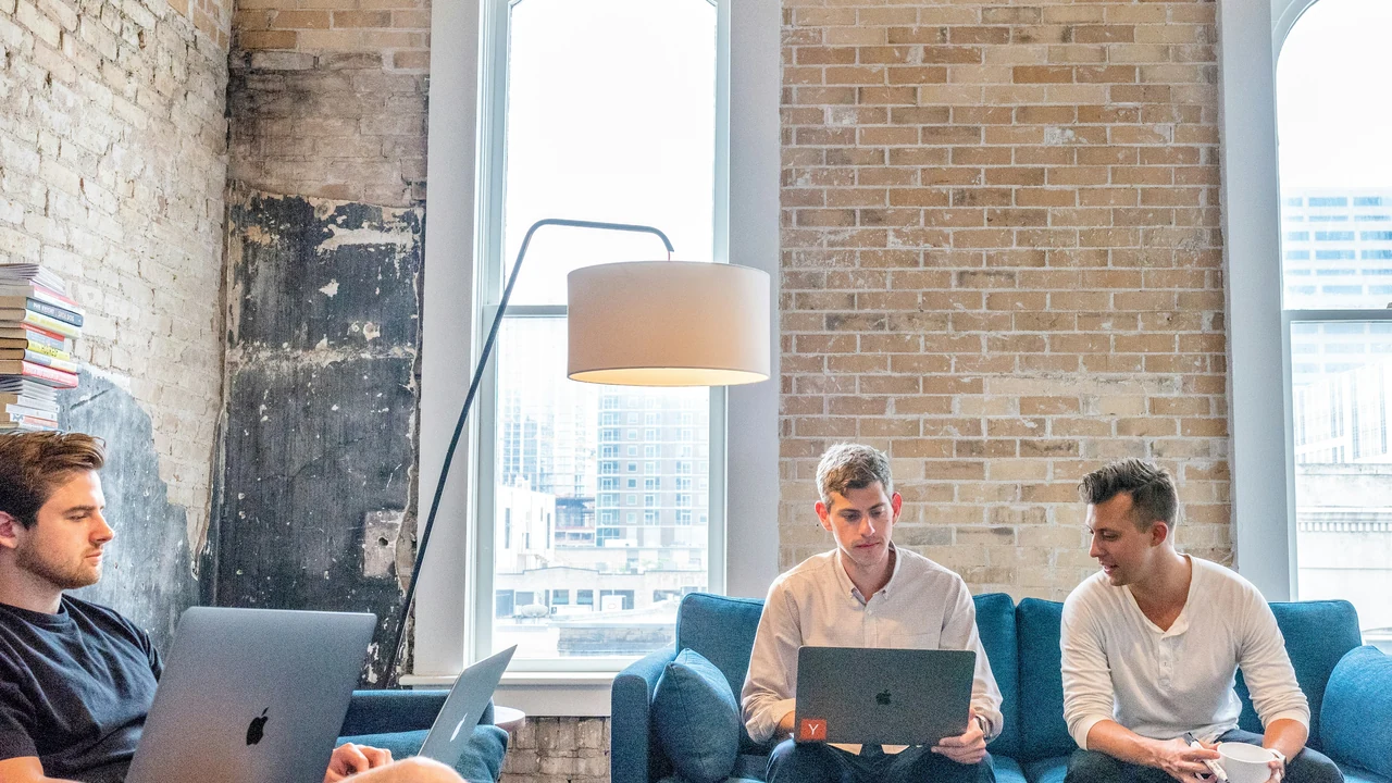 Marketing professionals reviewing campaign work on laptops.