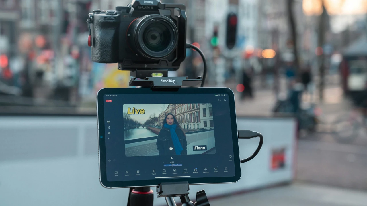 Camera and tablet filming vertical social media content in a city.