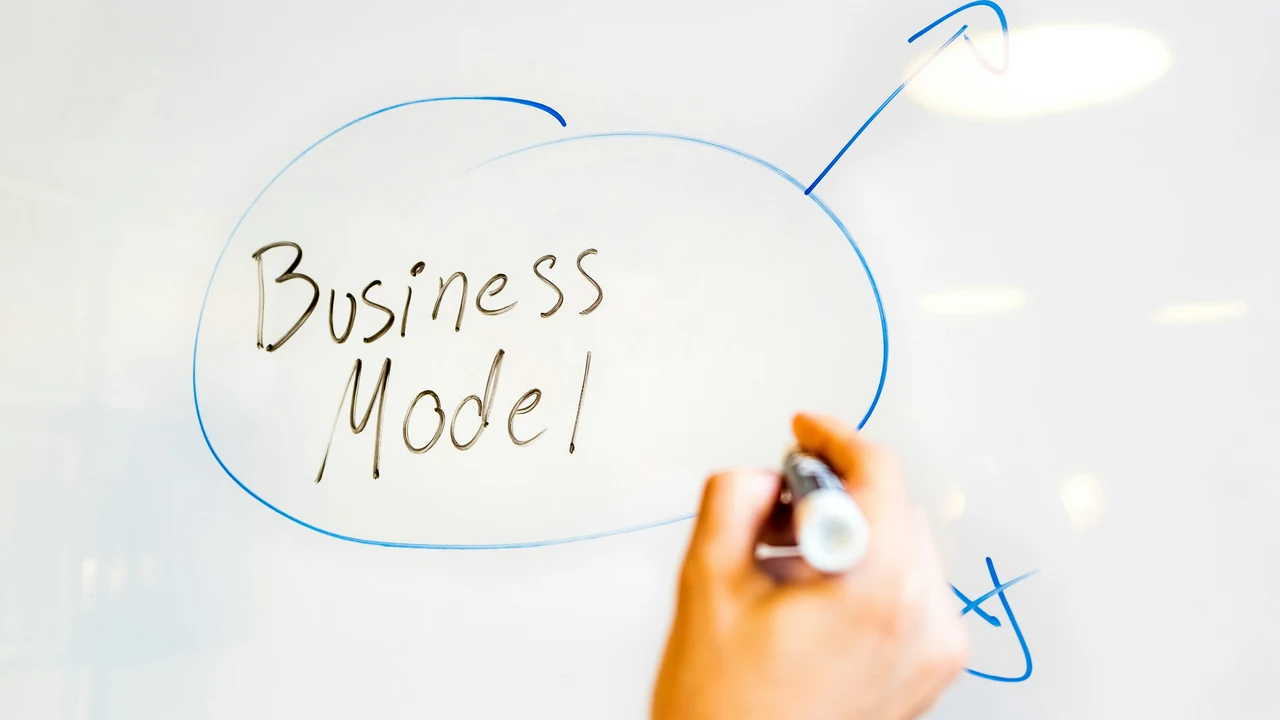 Professional documenting audit findings on a whiteboard.