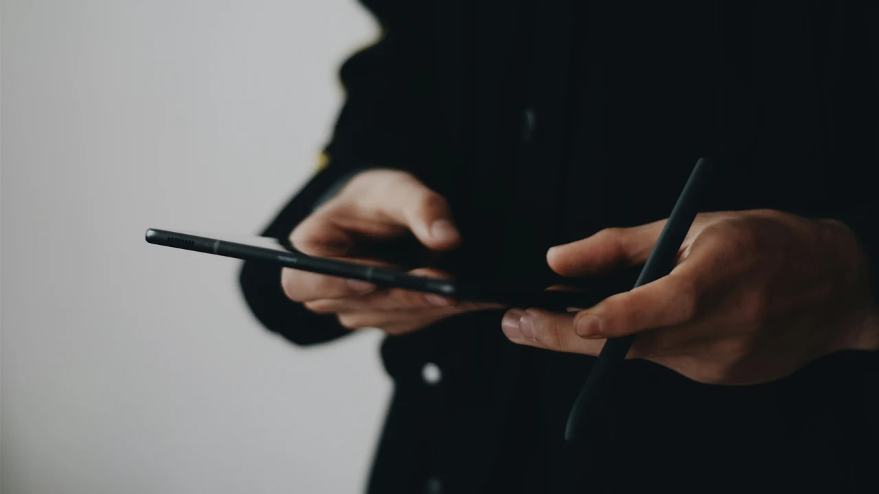 Person using a smartphone while navigating local businesses.