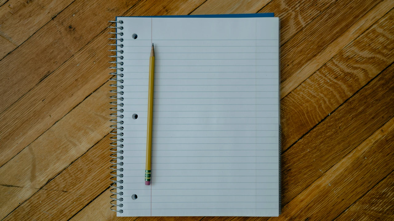 Open notebook and pencil prepared for keyword research notes.
