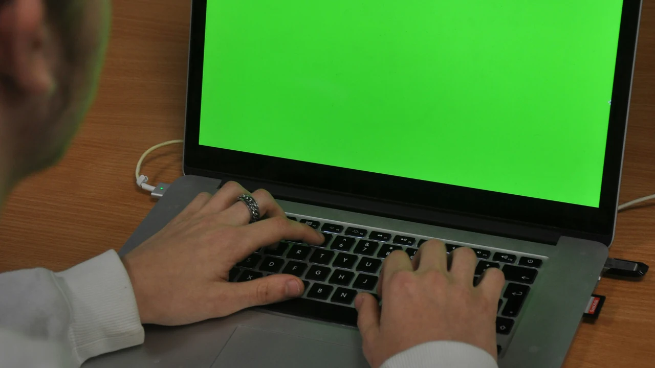 Business owner working at a laptop while managing online customer feedback.