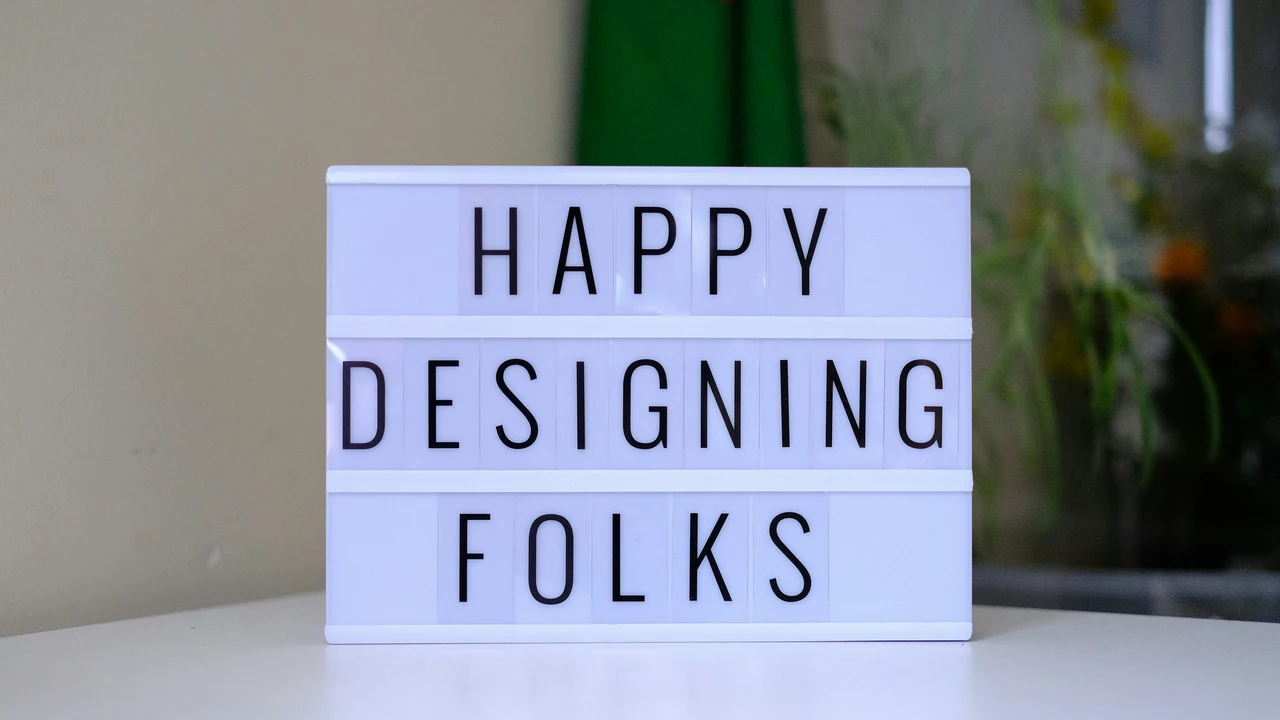 A light box that says happy designing folks.