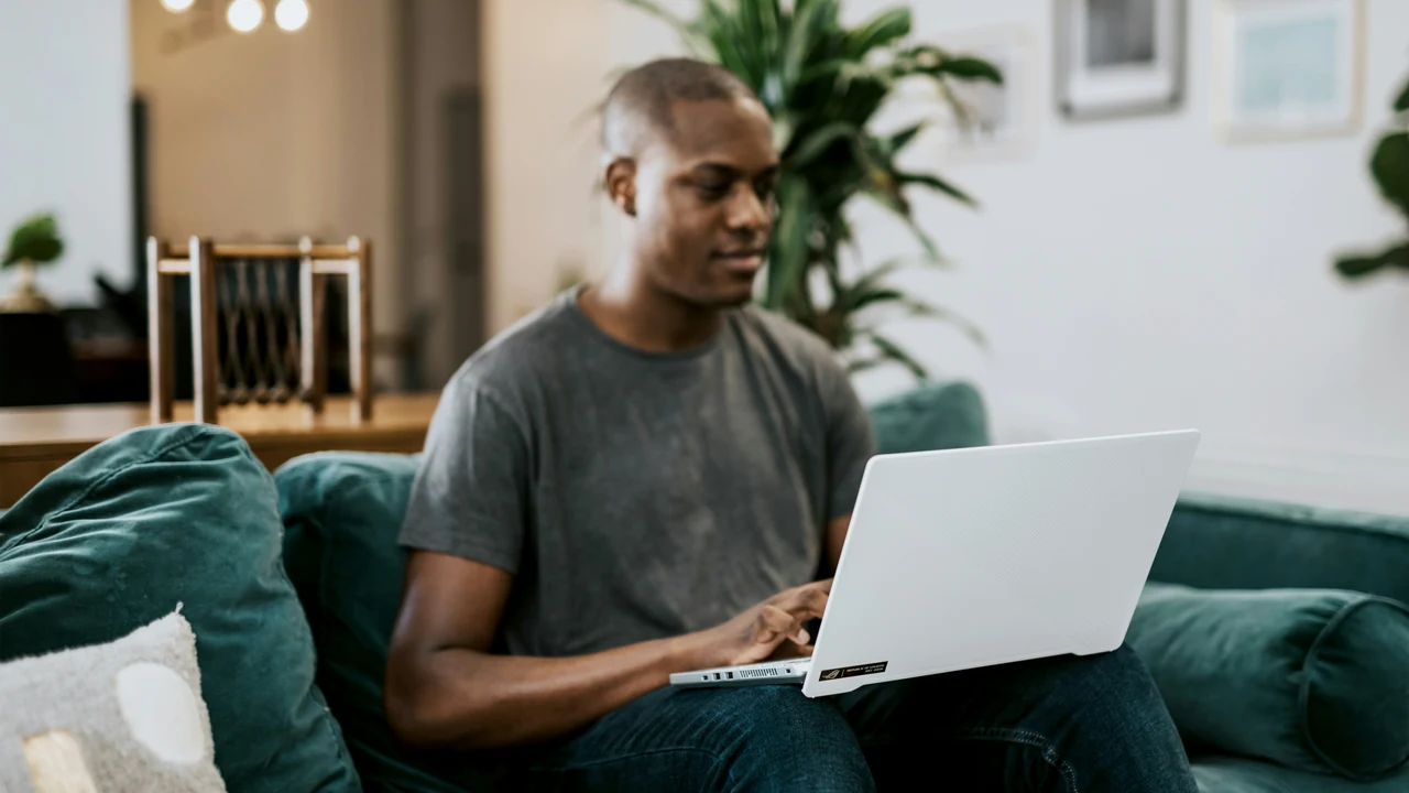 Man in gray crew neck t shirt using laptop.