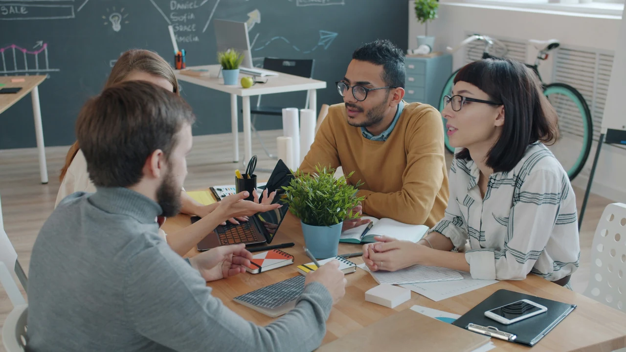 Diverse team collaborating around a table in a modern office.